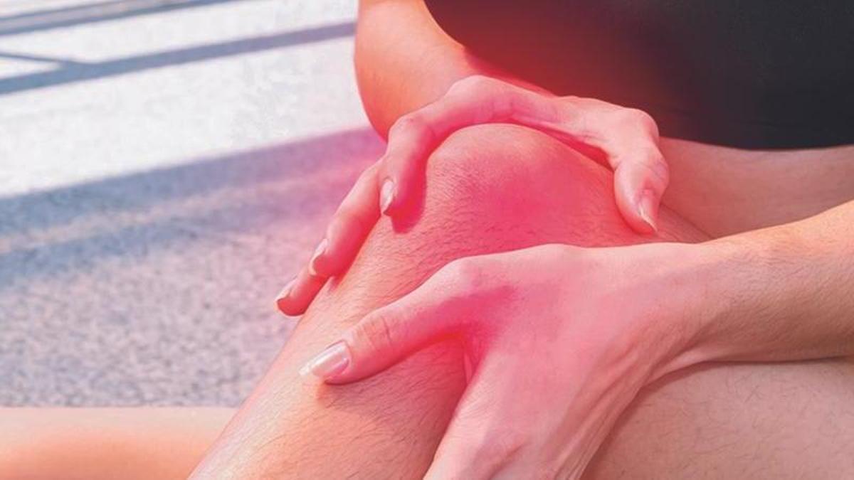 Young sport woman suffered from knee pain injury while running in city