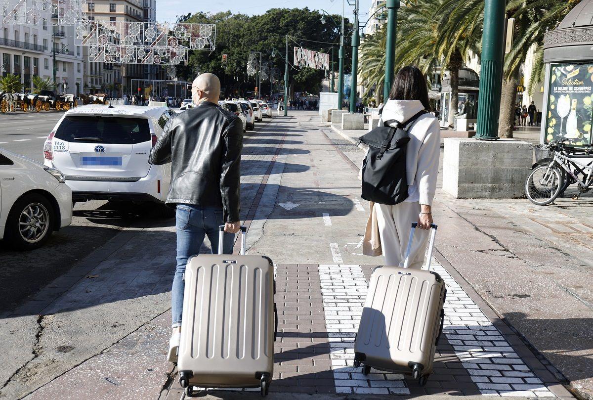 Turistas con sus maletas en el Centro de Málaga.