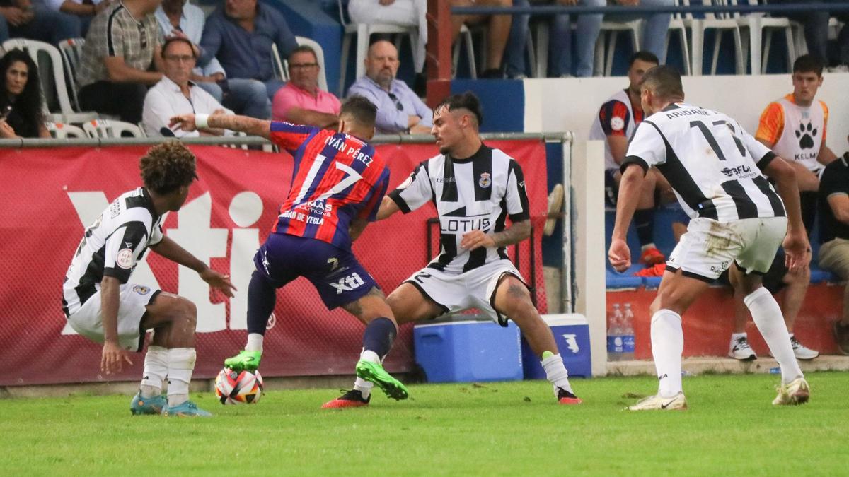 Iván Pérez intenta superar a un rival en el partido Yeclano-Linense
