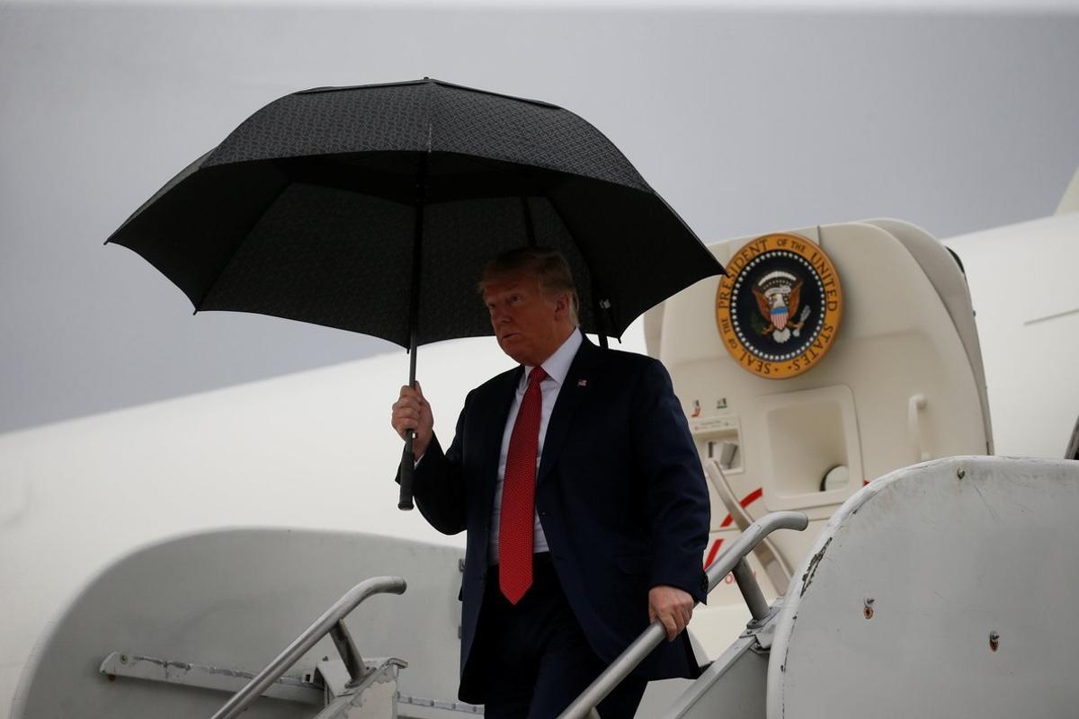 U S  President Donald Trump holds an umbrella as he arrives aboard Air Force One at Rochester International Airport in Rochester  Minnesota  U S   October 4  2018    REUTERS Leah Millis