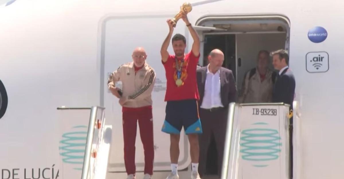 El seleccionador, Luis de la Fuente; el capitán de 'La Roja, Rodri Hernández; y el presidente de la Real Federación Española de Fútbol (RFEF), Rafael Louzán; con el trofeo de campeones del mundo.