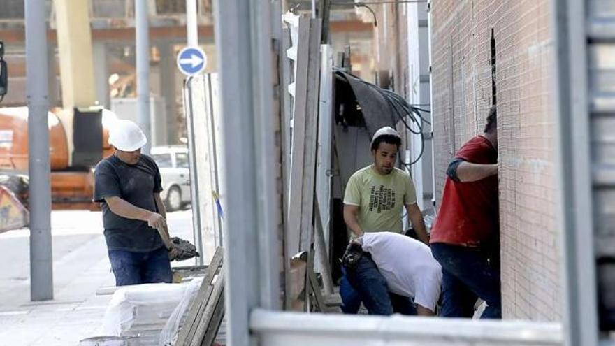 Operarios trabajando en la construcción de las viviendas de la Mayacina, en Mieres.