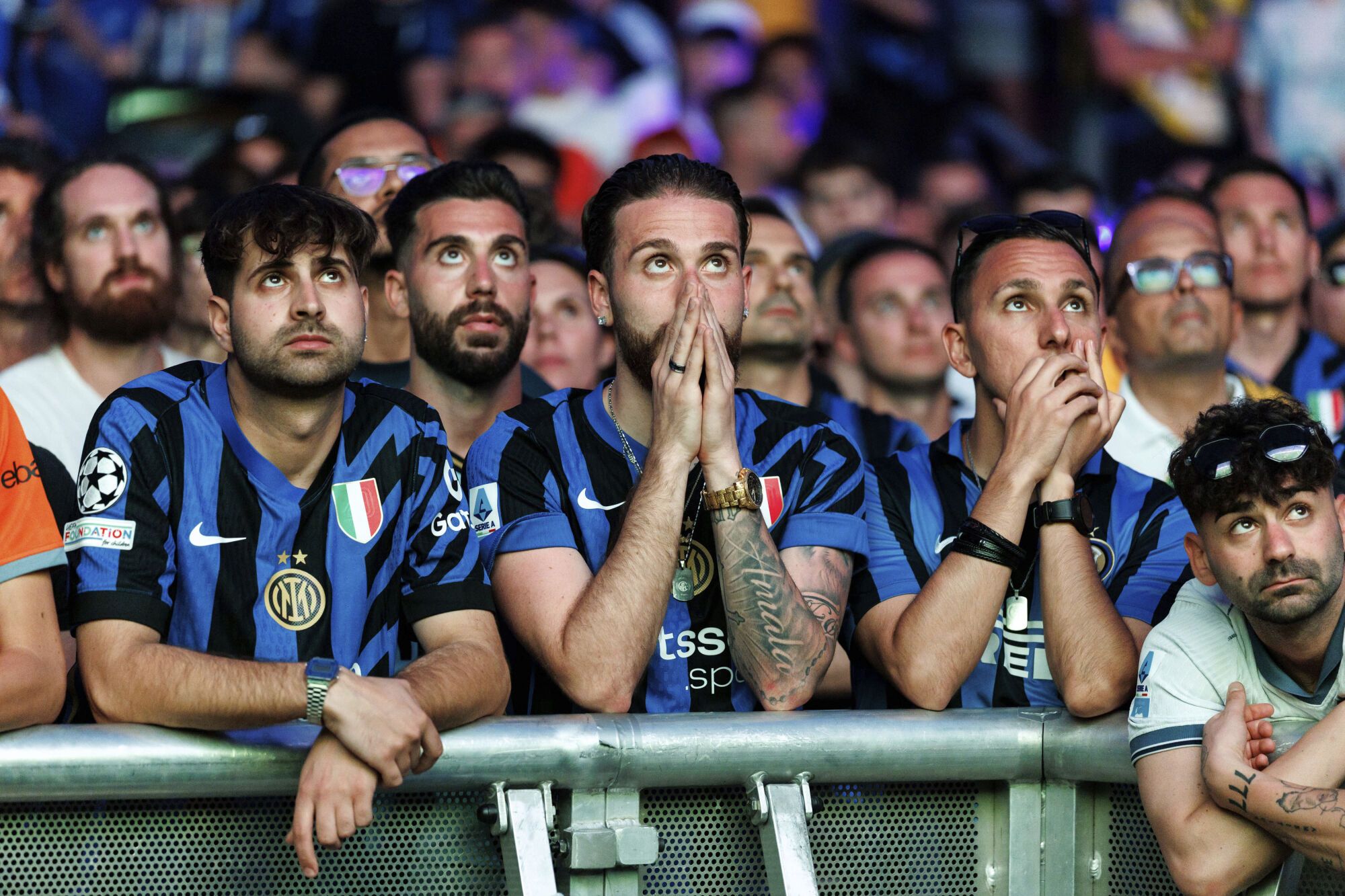 Inter Milan fans react as they watch their team play PSG in the Champions League final soccer match in the Fan Zone at the Olympiapark, Munich, Germany, Saturday May 31, 2025. (Matthias Balk/dpa via AP). EDITORIAL USE ONLY / ONLY ITALY AND SPAIN