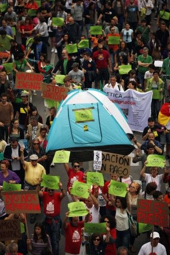 Demonstrators carry a tent as they march on the second anniversary of the 15M movement in Malaga