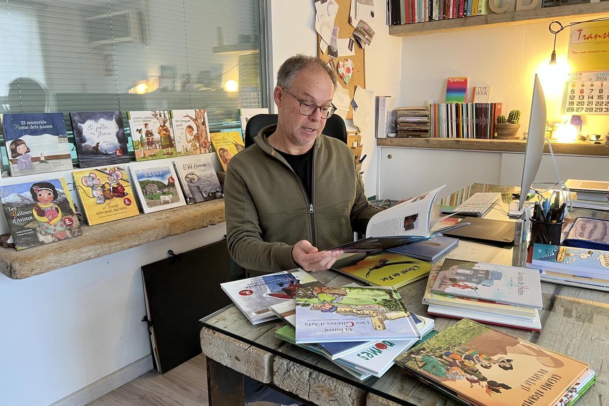 El director d'Edicions Salòria, Marcel·lí Pascual, repassant un dels exemplars publicats dins la col·lecció 'Petit Pirineu', dedicada a la literatura infantil i juvenil