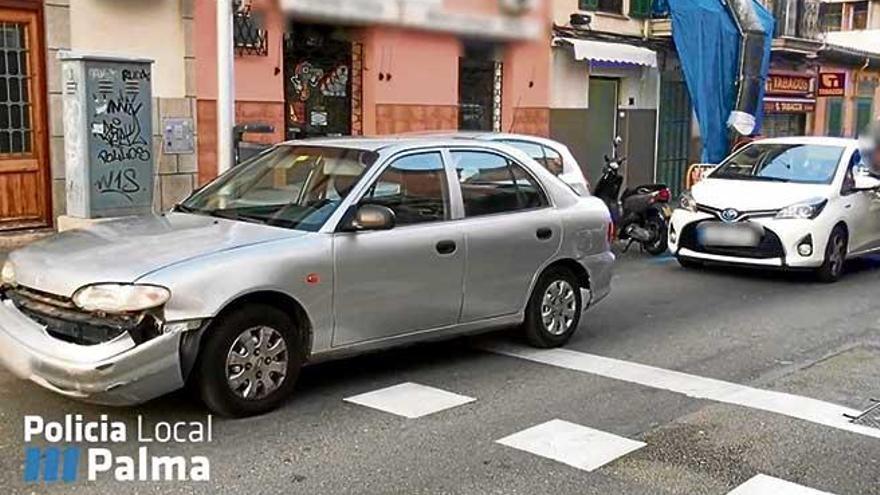 Un policía habla con la mujer que alertó de los hechos, junto al coche gris que conducía el septuagenario, a la izquierda.