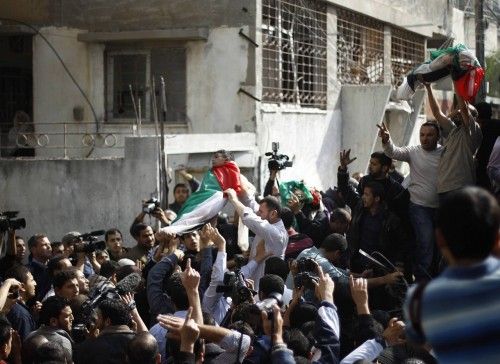Palestinians carry the bodies of two siblings during their funeral in Gaza City
