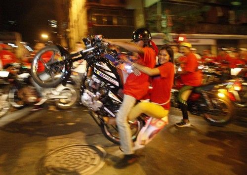 Supporters of Venezuelan presidential candidate Nicolas Maduro celebrate after the official results gave him a victory in Caracas