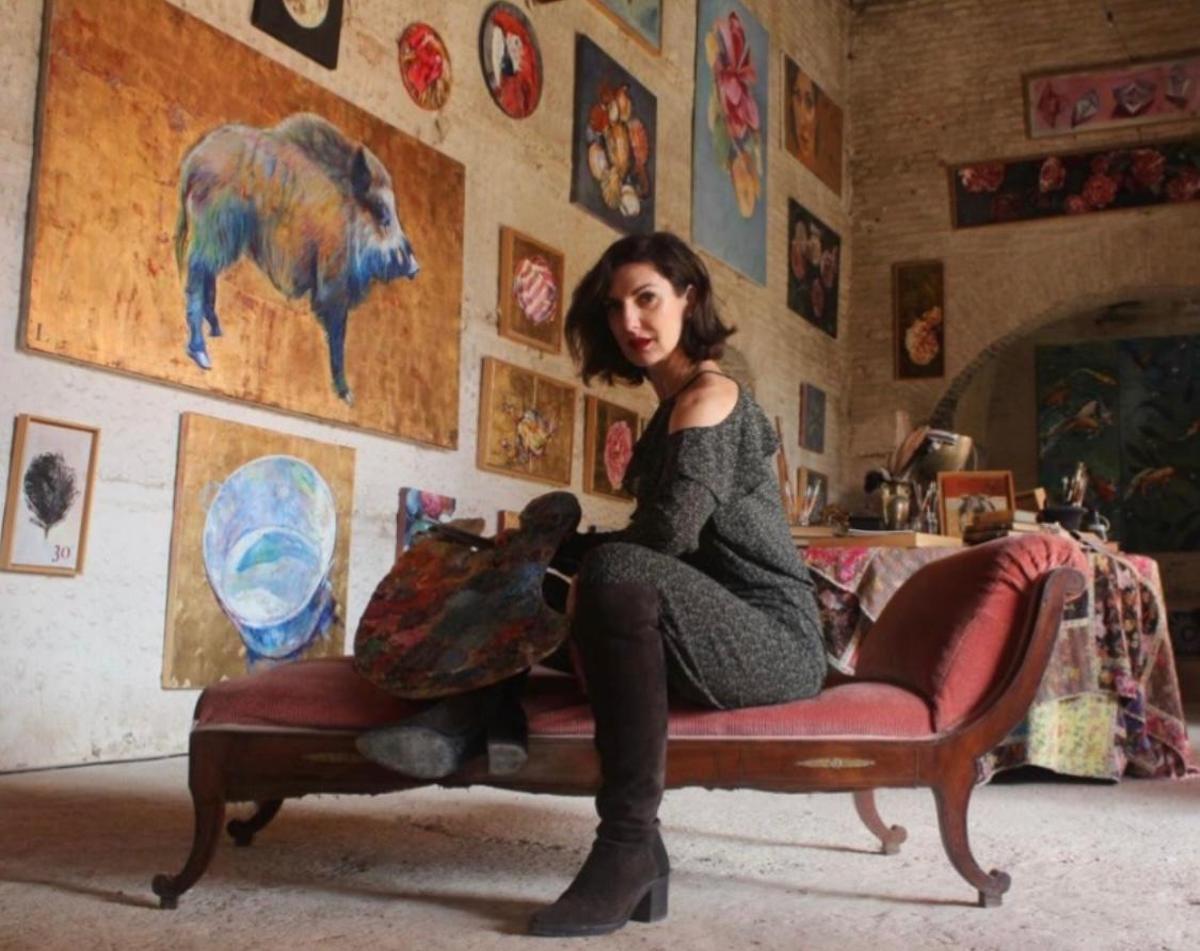 La artista Cristina Ybarra posando con algunas de sus obras