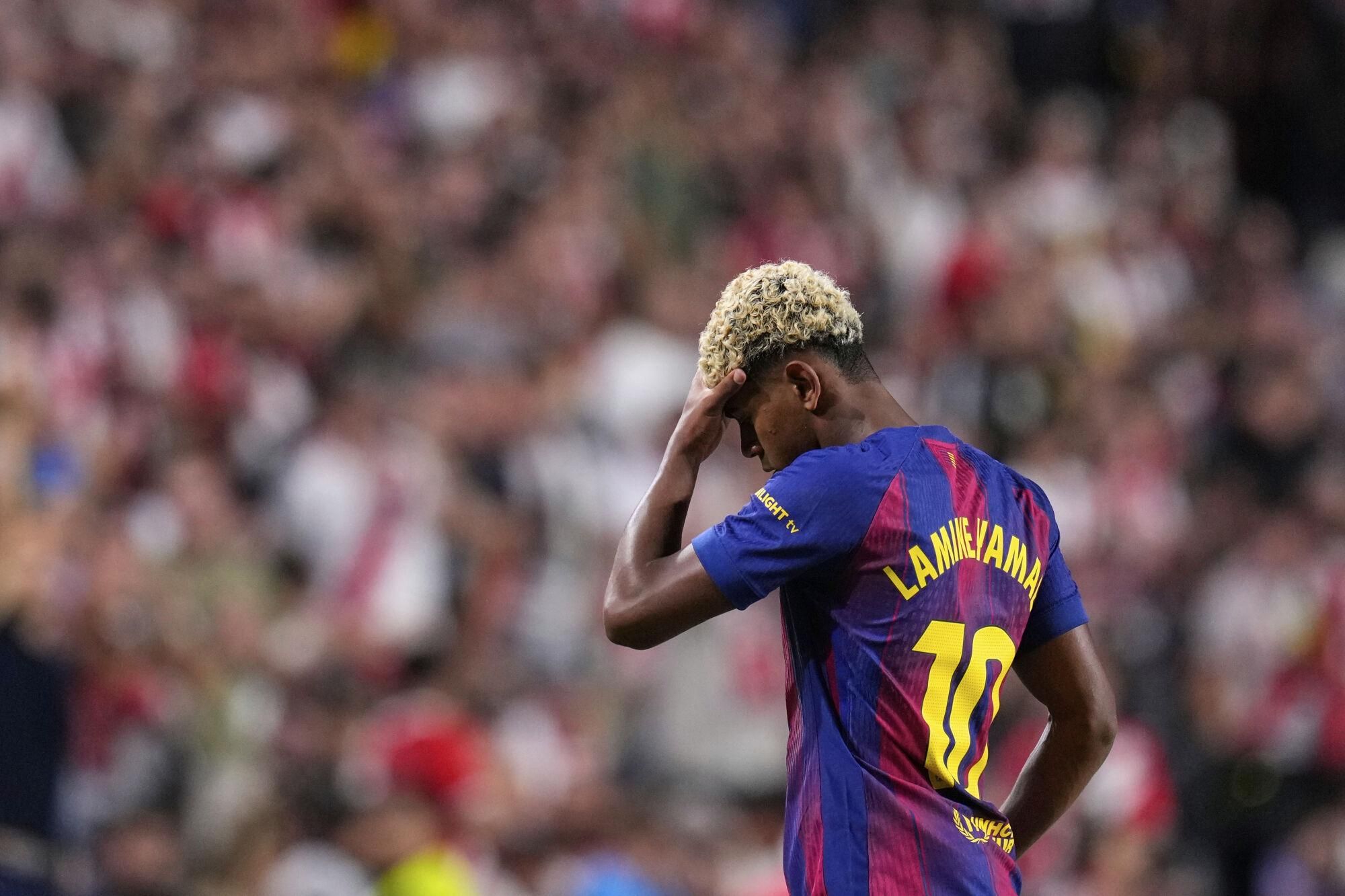 Barcelona's Lamine Yamal reacts during the Spanish La Liga soccer match between Rayo Vallecano and FC Barcelona at the Vallecas stadium in Madrid, Spain, Sunday, Aug. 31, 2025. (AP Photo/Manu Fernandez)