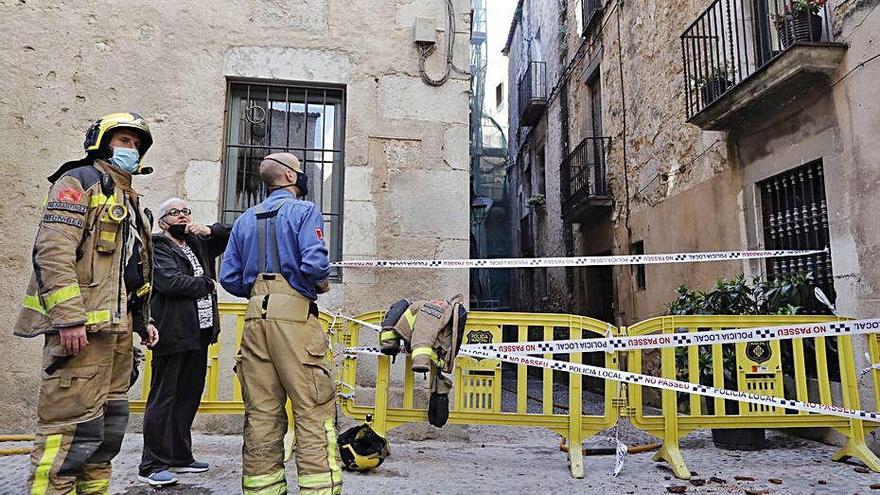 Els Bombers vigilant l&#039;edifici ahir al migdia.