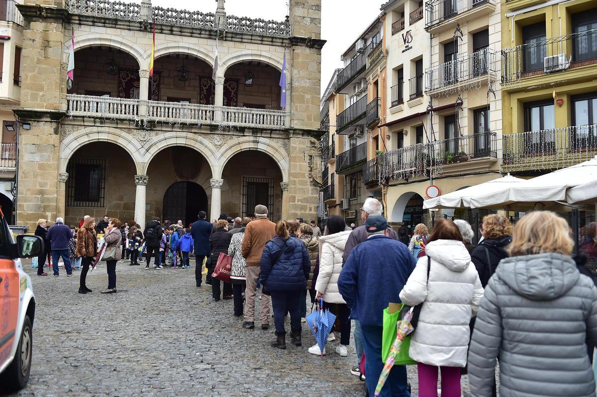 Cola para el reparto de migas y ponche por San Fulgencio en Plasencia.