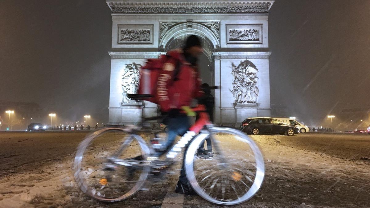 zentauroepp41934926 a cyclist rides through heavy snowfall as he passes by the a180207085128