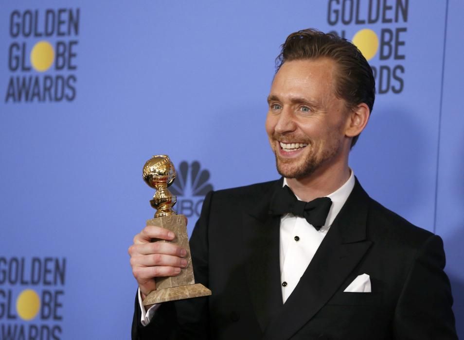 Tom Hiddleston holds his award during the 74th ...