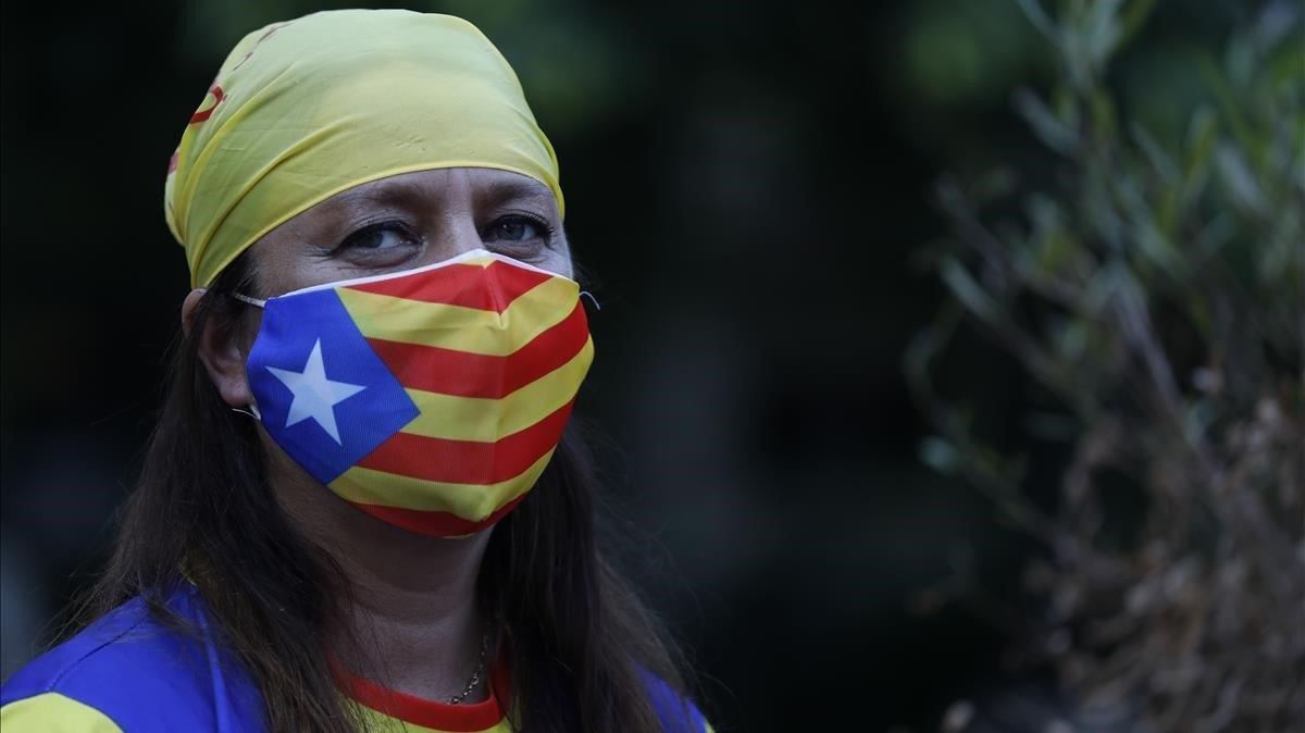 Una chica con una mascarilla con la bandera independentista