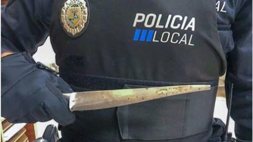 Un policía local sostiene el cuchillo que un individuo esgrimió contra ellos en Camp Redó.