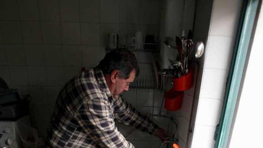 Un vecino de Segovia se dispone a calentar agua en la chimenea.