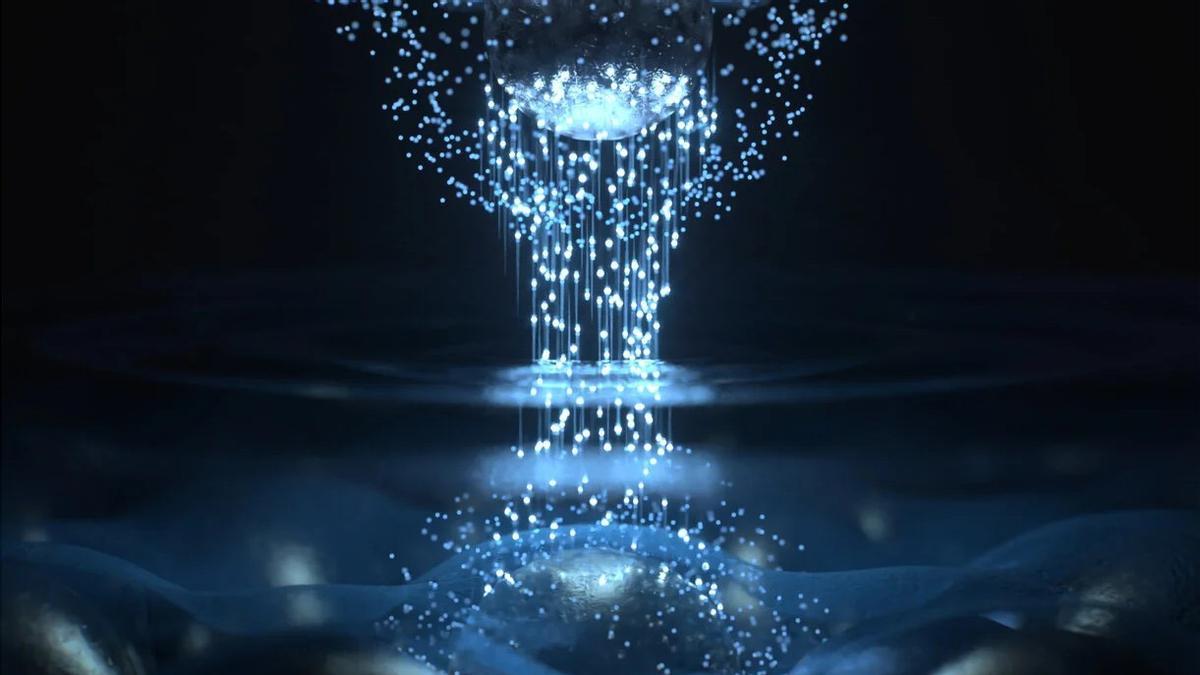 Representación artística de cómo la luz láser impulsa a los electrones (esferas brillantes) a saltar de un lado a otro entre el átomo del vértice de una punta metálica afilada (arriba) y una muestra (abajo), lo que da lugar a una emisión electromagnética que permite una microscopía totalmente óptica a escala atómica.