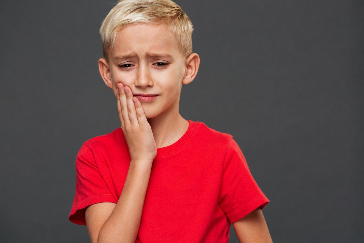 Sad little boy child with toothache