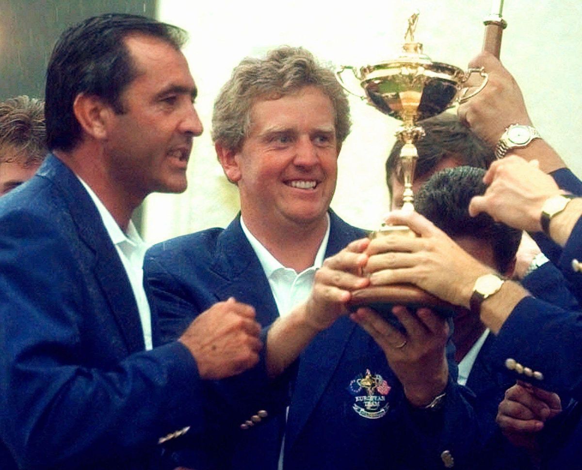 European Ryder Cup captain Seve Ballesteros, left, looks on as Scotland's Colin Montgomerie, centre, holds the Ryder Cup after Europe retained the trophy by 14 1/2 points to 13 1/2 at Valderrama golf course Sunday Sept. 28, 1997. (AP Photo/Lynne Sladky)
