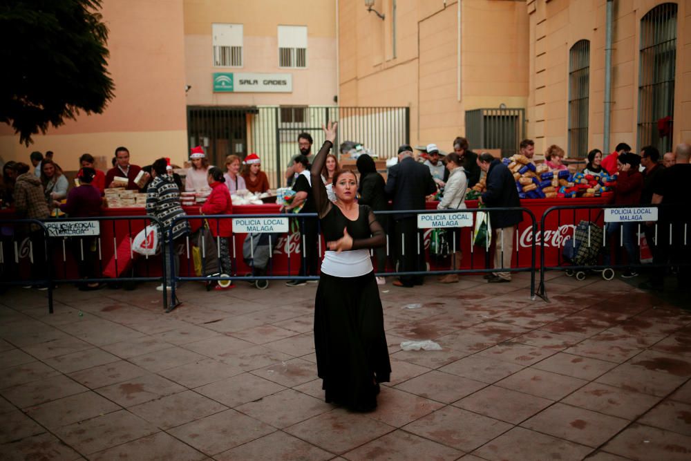 A dancer performs while people receive food ...