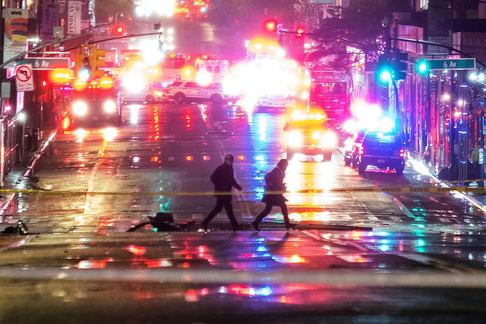 People walk near the scene of debris fallen due ...