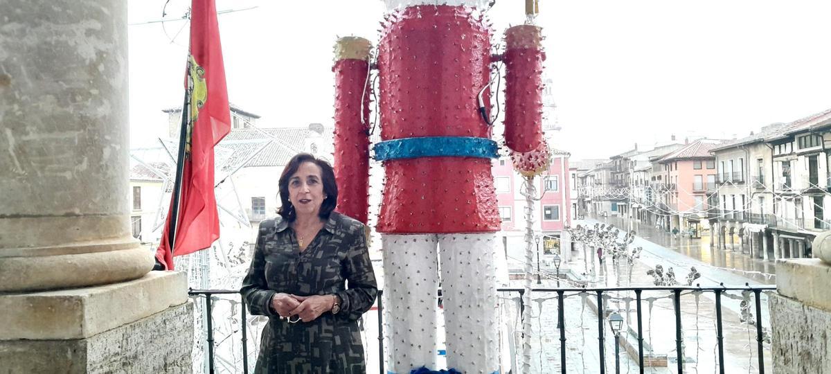 Ángeles Medina posa en el balcón del Consistorio, engalanado con la decoración navideña.