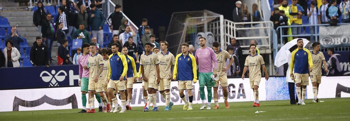 Los jugadores de la UD, abatidos, abandonan La Rosaleda tras perder con el Málaga.