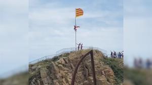 Un hombre intenta arrancar una bandera de Cataluña para sustituirla por una de España