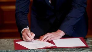 Spanish acting Prime Minister Pedro Sanchez signs a coalition agreement during a news conference with Unidas Podemos (Together We Can) leader Pablo Iglesias (not pictured) at Spain’s Parliament in Madrid, Spain, November 12, 2019. REUTERS/Sergio Perez