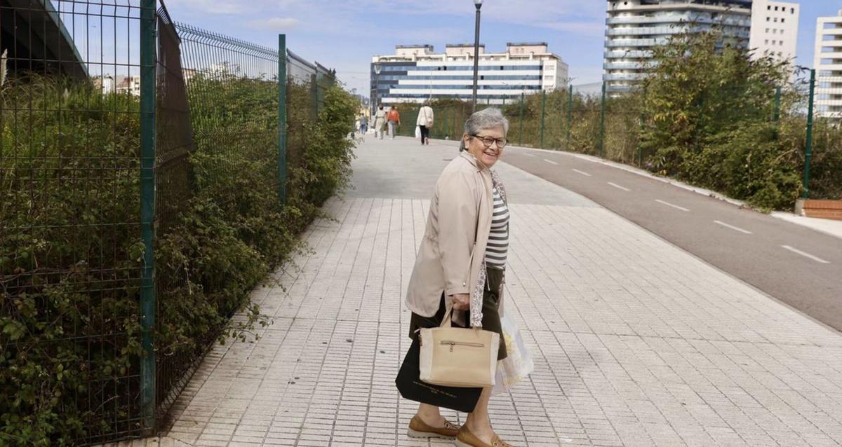Mari Rodríguez, junto a una de las vallas donde la vegetación crece sin control. | MARCOS LEÓN