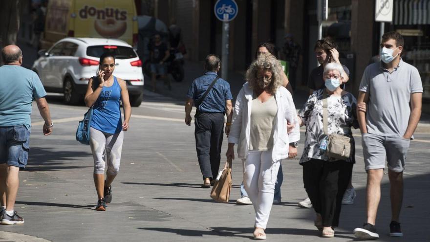 Persones caminant per Manresa, d’on l’Ajuntament vol bandejar els cotxes