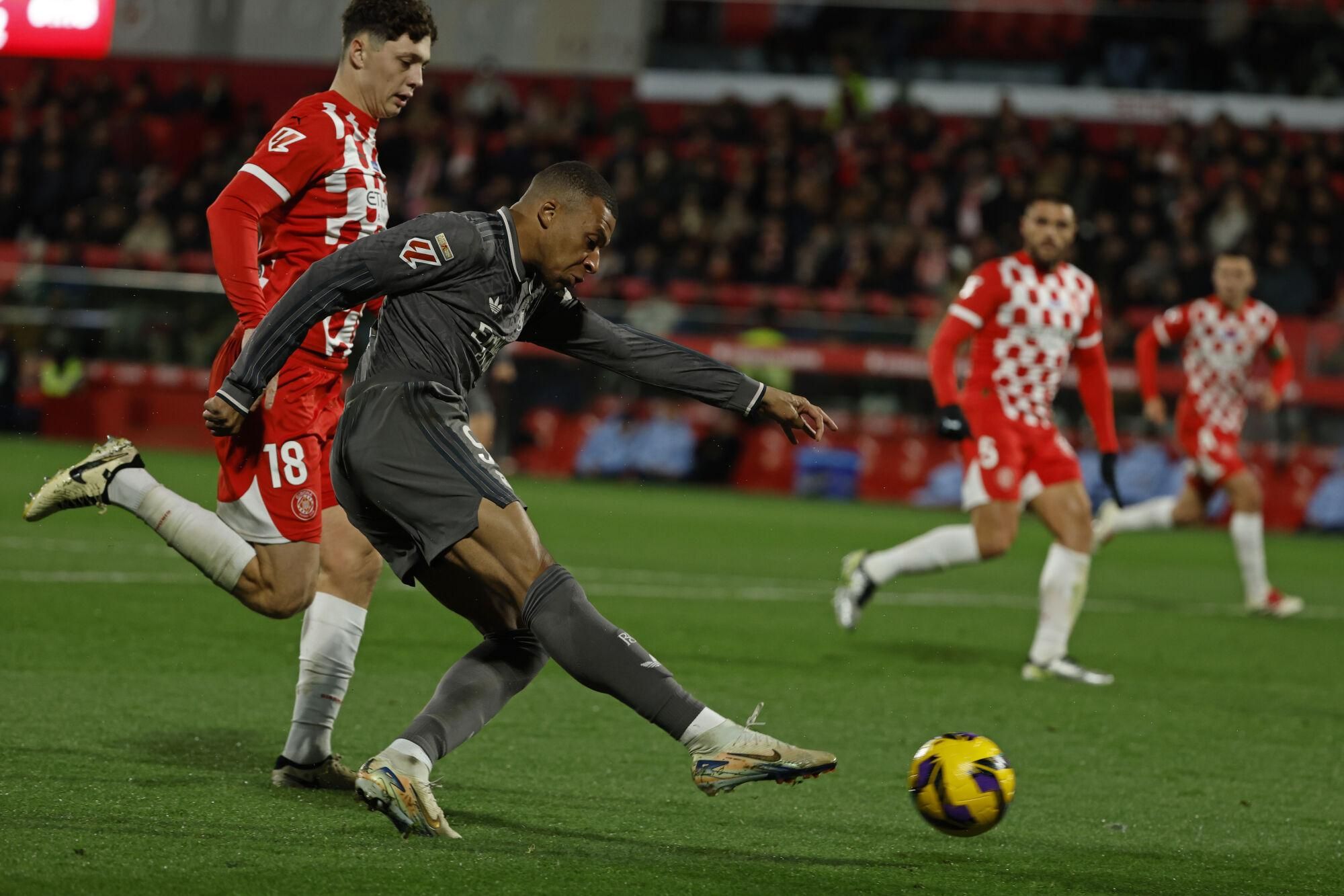 Real Madrid's Kylian Mbappe scores his side's third goal during a Spanish La Liga soccer match between Girona and Real Madrid at the Montilivi stadium in Girona, Spain, Saturday, Dec. 7, 2024. (AP Photo/Joan Monfort). EDITORIAL USE ONLY/ONLY ITALY AND SPAIN