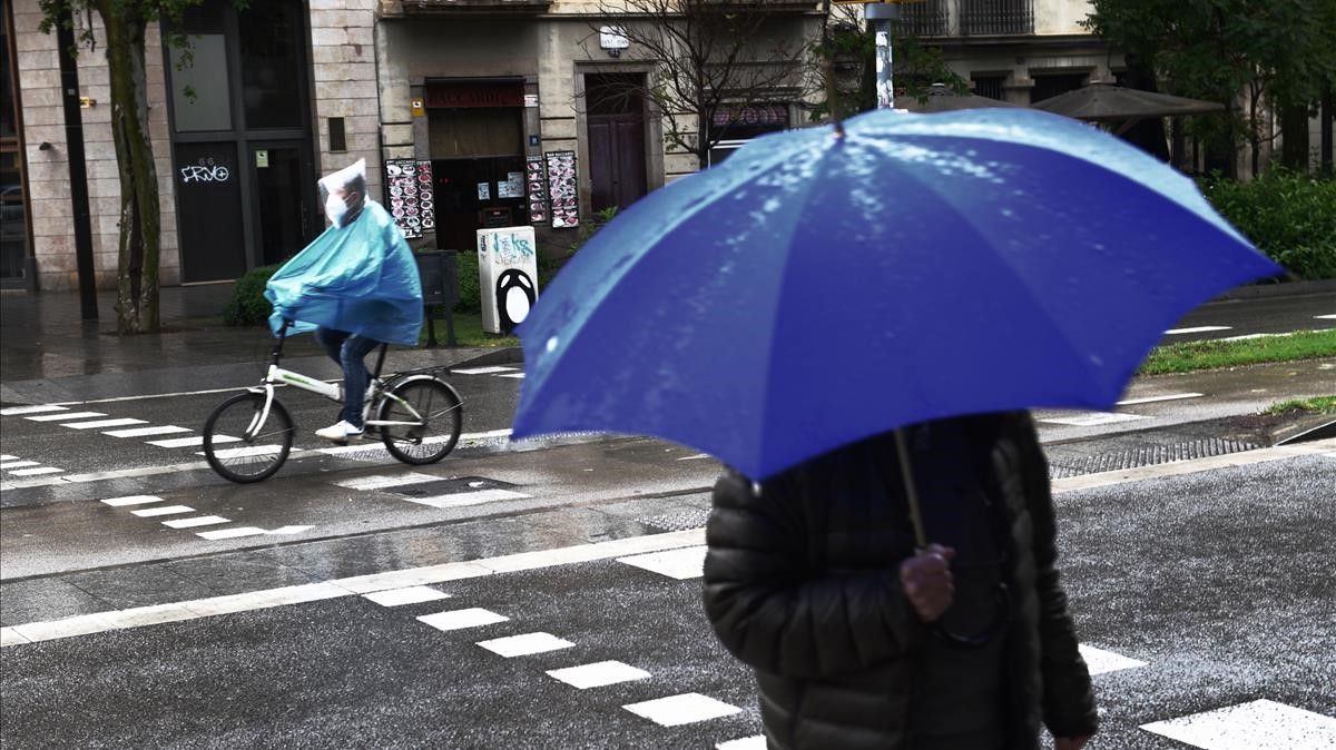Barcelona  01 05 2021  Barcelona    Paseantes protegidos con paraguas para la ligera lluvia que cae en la ciudad esta manana  Fotografia de Jordi Cotrina