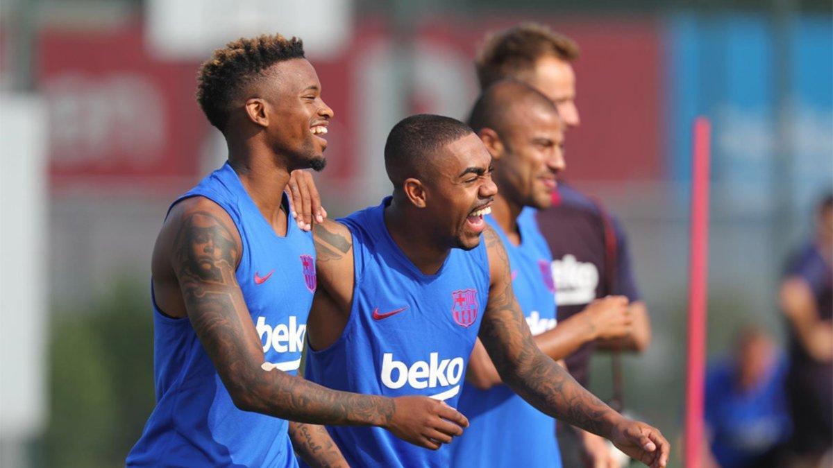 Nelson Semedo, Malcom (centro) y Rafinha durante el entrenamiento del FC Barcelona del lunes 15 de julio
