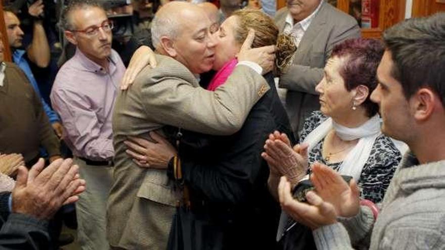 Un vecina besa al alcalde de Boqueixón tras presentar su dimisión. / efe