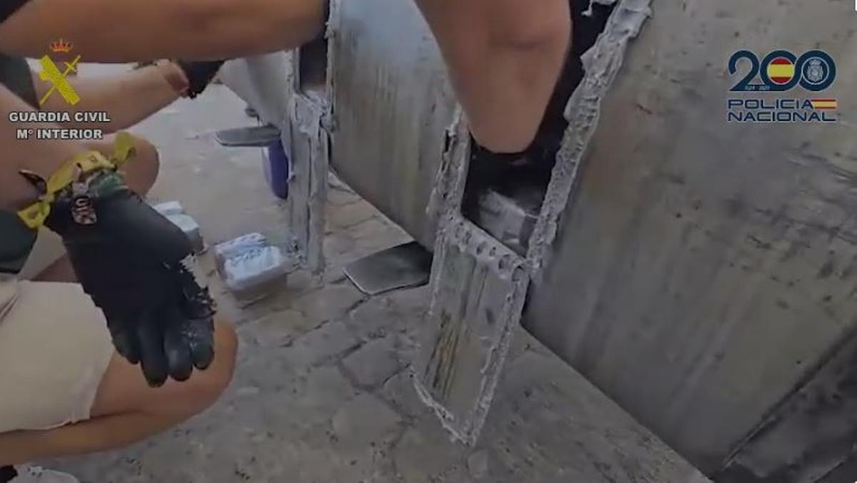 Agentes extraen droga del depósito de combustible de un camión.