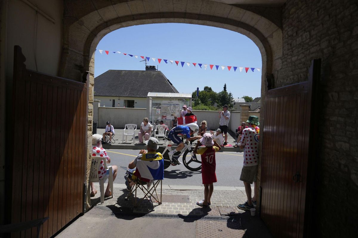 Supporters watch Quinn Simmons of the U.S. during the fifth stage of the Tour de France cycling race, an indivdual time-trial over 33 kilometers (20.5 miles) with start and finish in Caen, France, Wednesday, July 9, 2025. (AP Photo/Mosaab Elshamy)