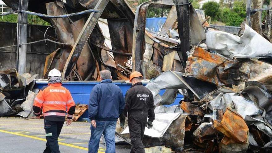 Bomberos y Policía Judicial, ayer, ante las ruinas de la nave que se incendió el lunes. // Gonzalo Núñez