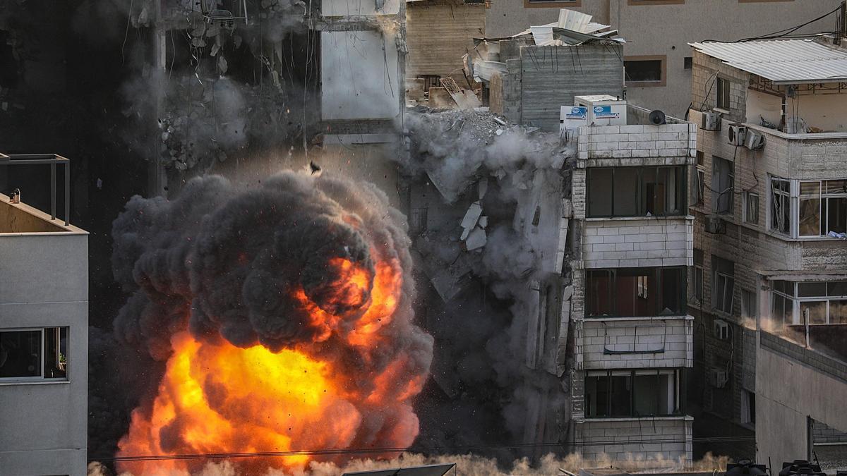 Smoke and flames rise after an Israeli strike Al-Shorouq tower in Gaza City