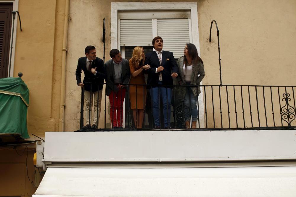 People wait on a balcony to watch the penitents ...