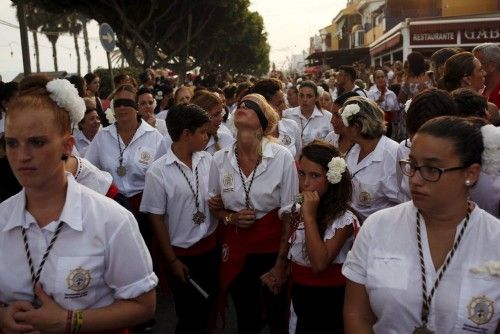 People in traditional costumes take part in the procession of the El Carmen Virgin being carried into the sea in Malaga