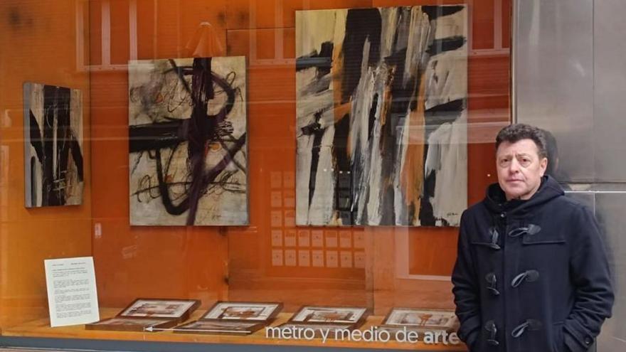 Gil Morán, delanrtre del escaparate de &quot;Metro y medio de arte&quot; colos sos cuadros.