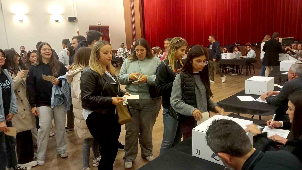 Un grupo de falleras espera para depositar su voto en la urna