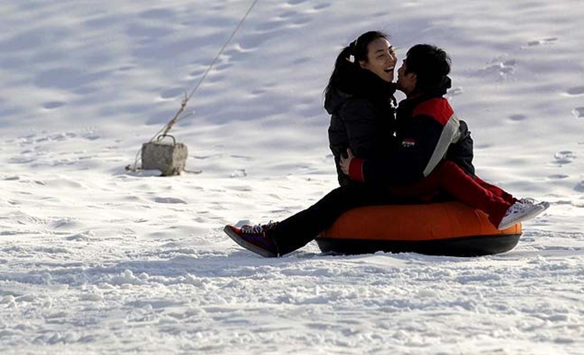 Una parella juga al gel després de la cerimònia d’obertura de l’Antic Palau d’Estiu Imperial de Gel i del Festival de Neu a Pequín (Xina). El festival, que comença dimecres, combina esports de gel i neu amb presentacions culturals.