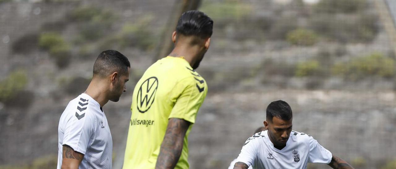 Vitolo, a la izquierda de la imagen, observa como Jonathan Viera controla un balón en un rondo, ayer en Barranco Seco. | | UDLP