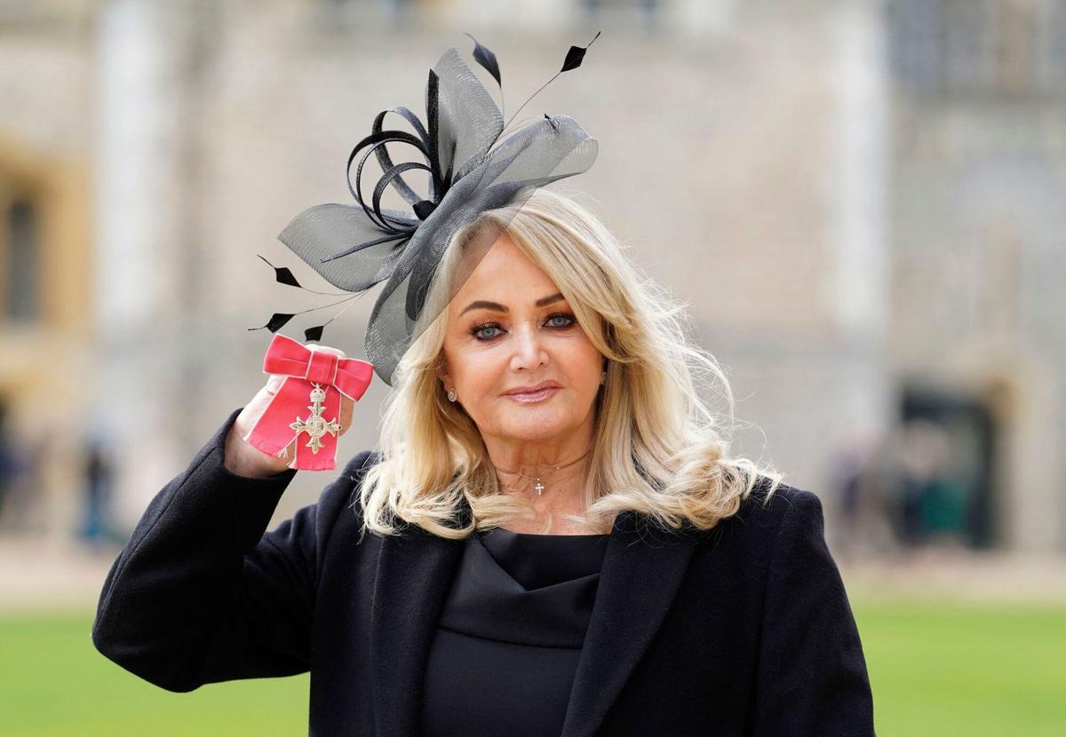 (FILES) British singer Gaynor Sullivan aka Bonnie Tyler poses with her medal after being appointed a Member of the Order of the British Empire (MBE) during an investiture ceremony at Windsor Castle in Windsor, west of London, on February 1, 2023. Welsh singer Bonnie Tyler best known for her powerful, haunting love song "Total Eclipse of the Heart" has died at the age of 75, her family announced on July 9, 2026. (Photo by Andrew Matthews / POOL / AFP)