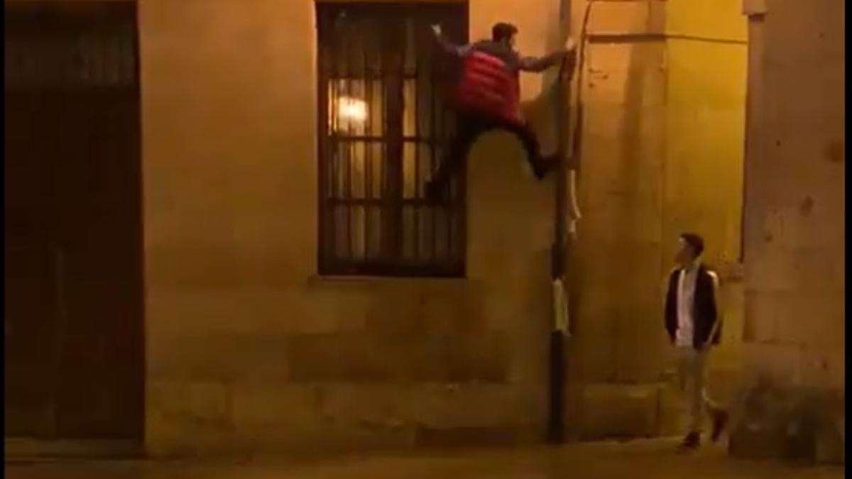 Captura del vídeo viral en el que se ve al joven trepando por un canalón del Ayuntamiento.