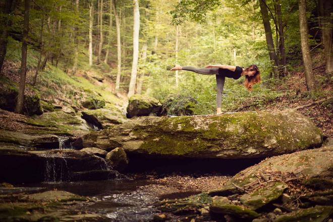 Beautiful woman practicing yoga in nature