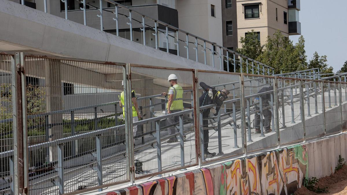 Operaris donaven este divendres els últims retocs a la barana de la passarel·la sobre la via del tren al barri d'Elx d'Altabix